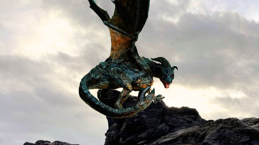 A terrifying 15 foot Cornish dragon perched on a rock and looking scarily at the camera